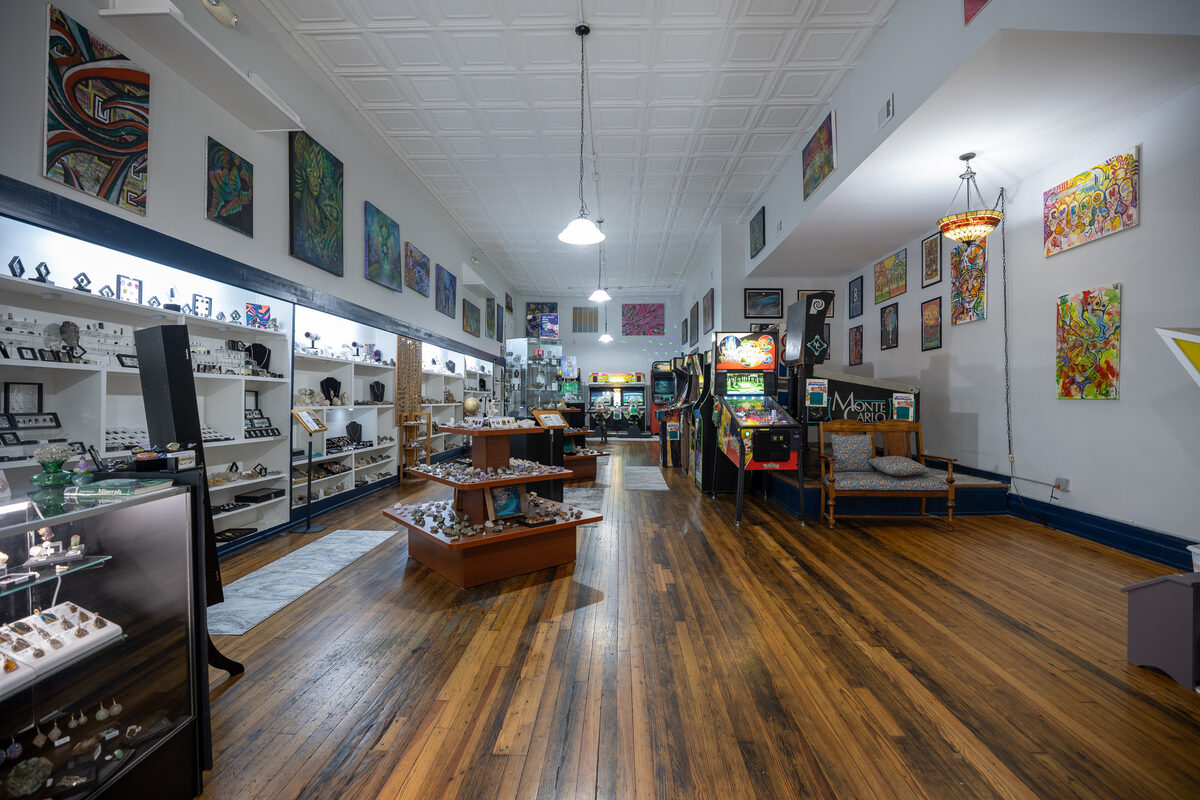 Inside The Art-Cade: display cases, the art wall and the arcade at the back